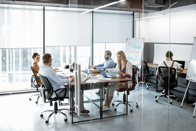 Team Working in Glass Partitioned Office