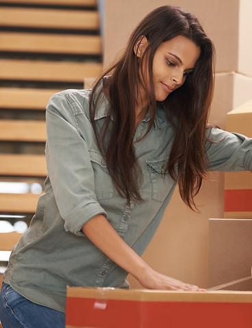 Young woman setting a box down