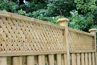 Wooden fence with decorative trellis