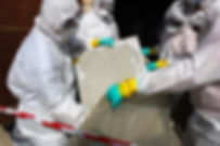 workers removing asbestos from a building