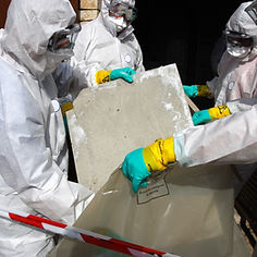 Men in protective white gear collecting asbestos