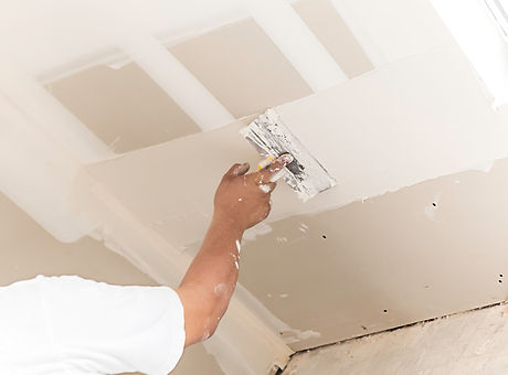 Man spackling new drywall or plasterboard