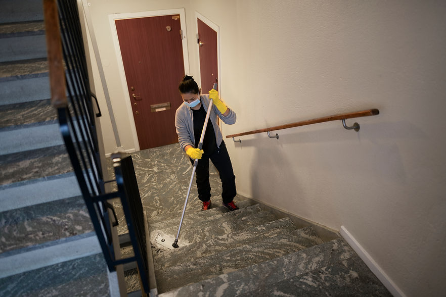 Woman mopping staircase