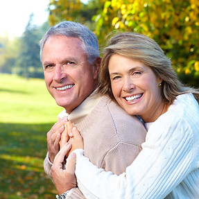 Happy elderly seniors couple in park