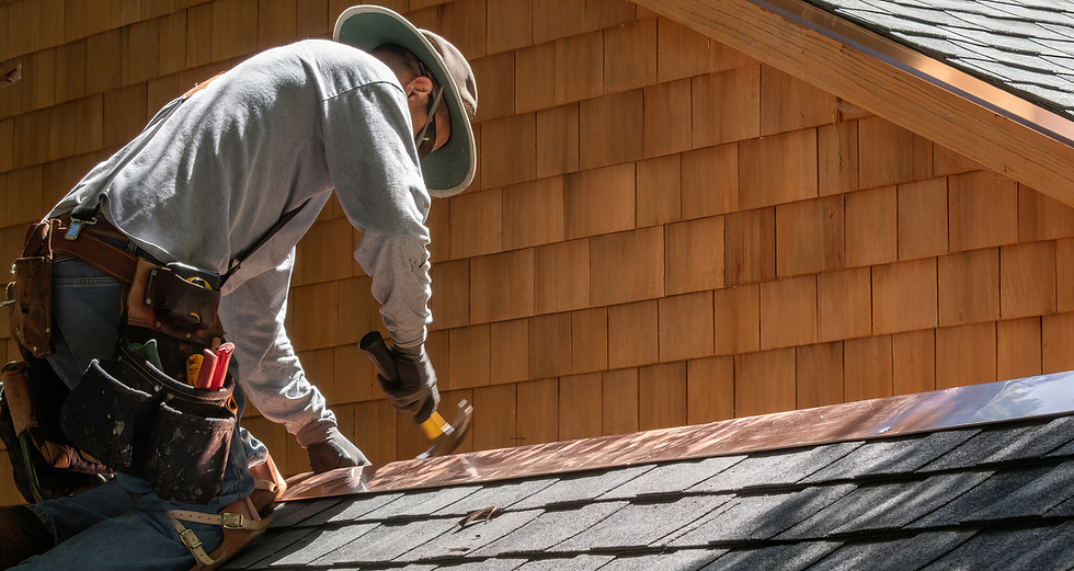 A Roofer Fixing Shingles Roof