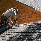 A Roofer Fixing Shingles Roof