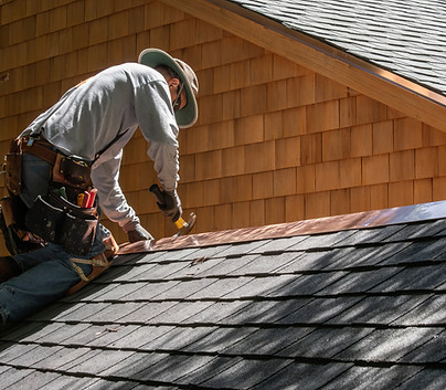 A Roofer Fixing Shingles Roof