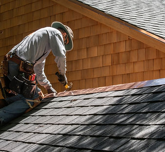 A Roofer Fixing Shingles Roof