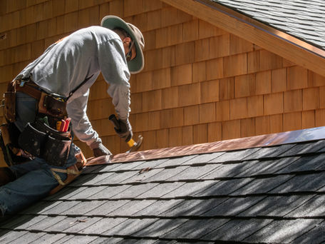 a roofing installer adding shingles to a roof near Tampa FL