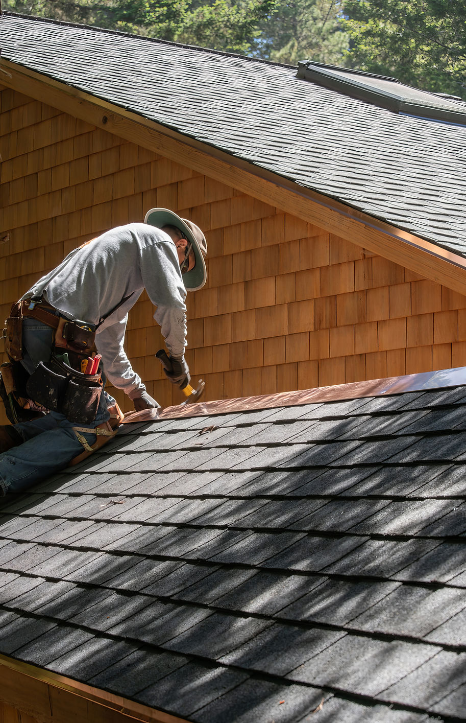 A Roofer Fixing Shingles Roof