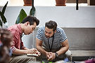 Men discussing and taking notes