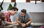 Men discussing and taking notes