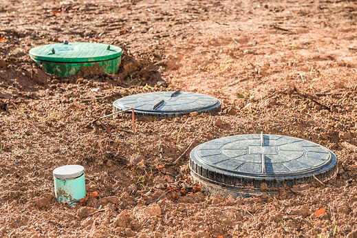 Multiple round septic tank lids installed in the ground