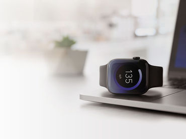 Smartwatch sitting on a laptop