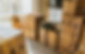 A sunny living room with many cardboard boxes, filled with possessions, alluding to moving