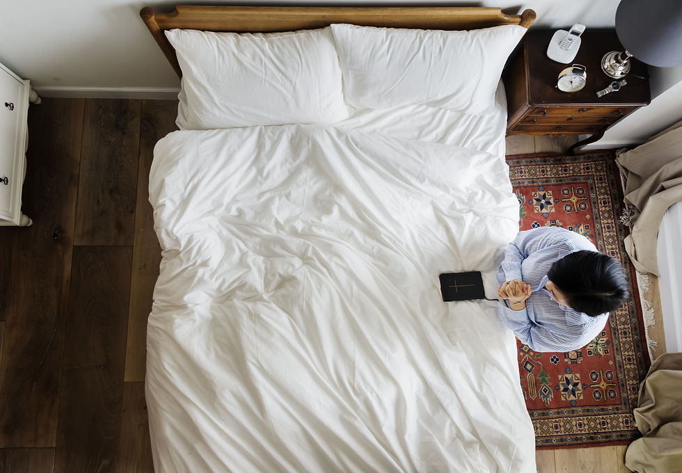 Person Praying Next To Bed