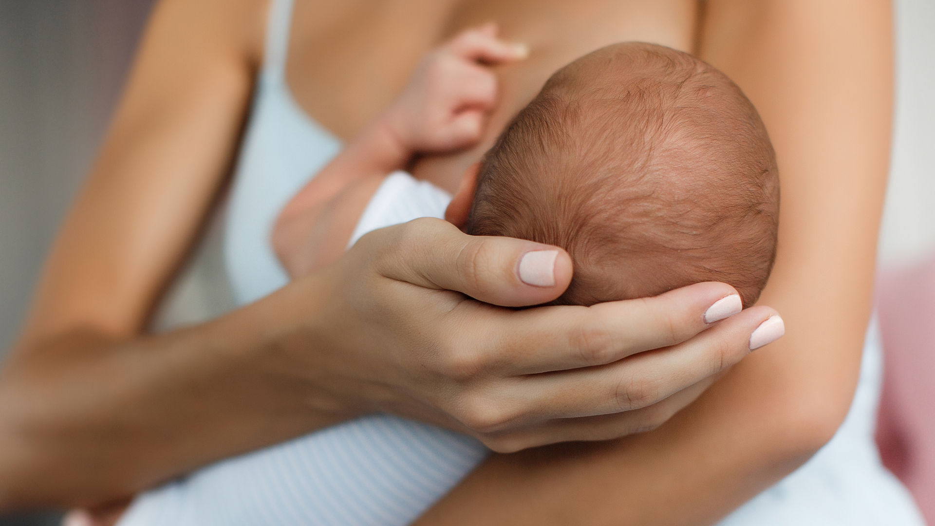 Mother nursing newborn