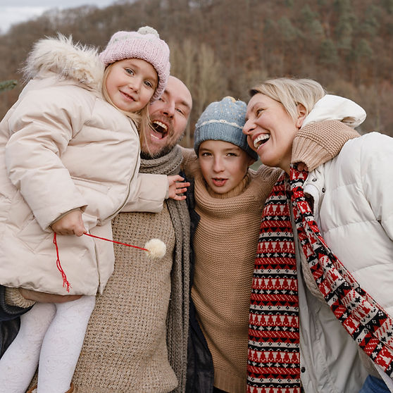 Family of four laughing together after a therapy session