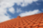 Brand new red rooftop against blue sky