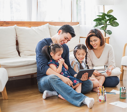 "Photo of a family gathered around a table, engaging in a learning activity together, symbolizing collaboration and education