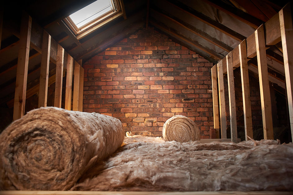 rolls of insulation partially installed in a loft space