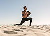 Man with a medicine ball exercising at the Beach
