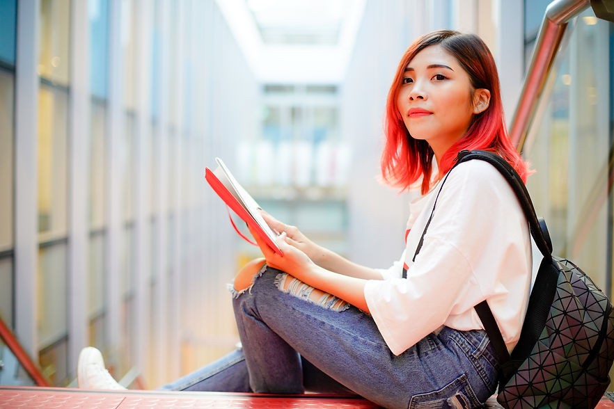 Young Asian girl sitting in an university campus