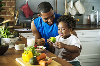 Parent cooking healthy food with child