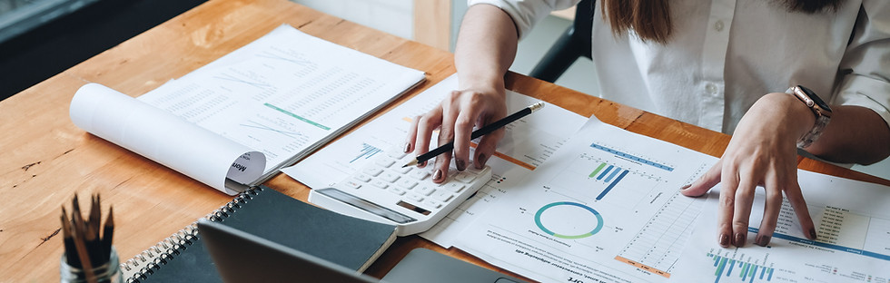 Person analyzing financial reports with charts and KPIs