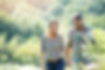 A couple holding hands on a walk.