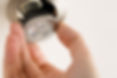 A male hand is installing a LED light bulb into a ceiling can fixture