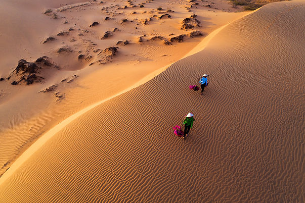 Women walking on Mui Ne sand dunes in Vietnam