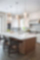 A stylish interior with bespoke lighting and white kitchen tops