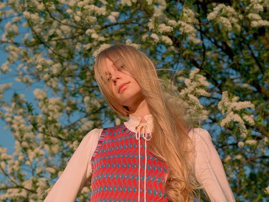 Blonde haired girl looks at camera
