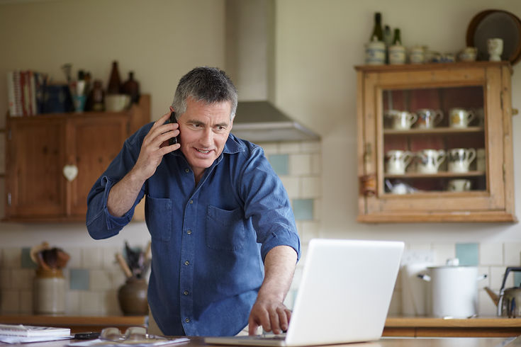 Man using phone and laptop