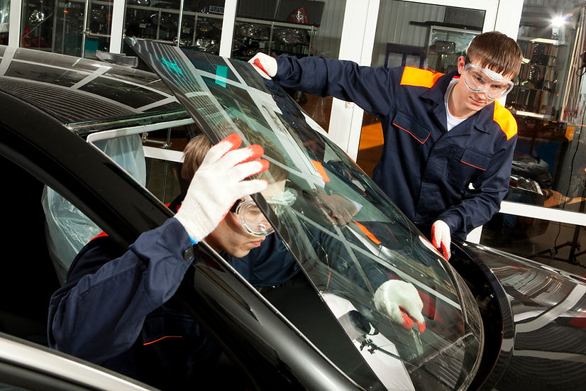 Two real mechanics working in an auto repair shop
