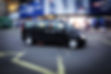 A Mercedes Vito London black cab passes through Piccadilly Circus in Central London
