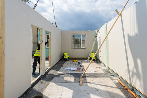 Professional construction workers in hard hats working on a residential building project in Arizona