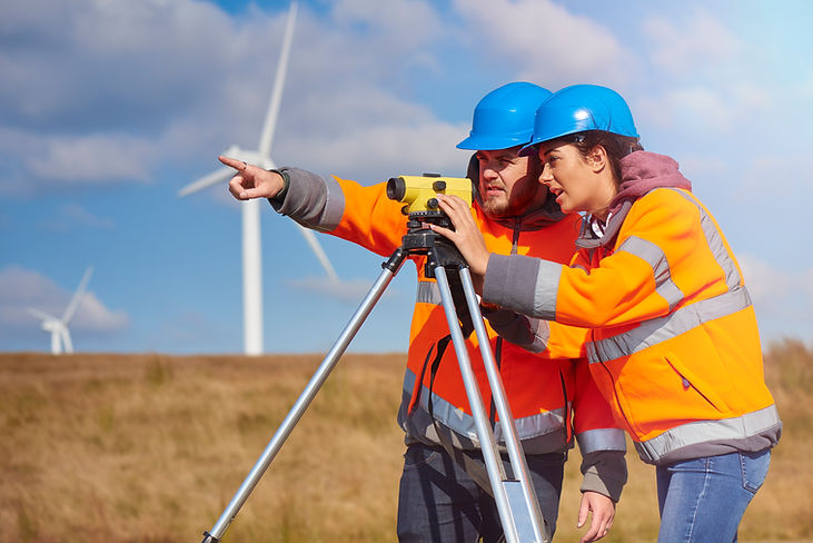 surveyors wearing hard hats and hi-vis jackets