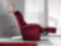 A burgundy riser recliner chair in a room