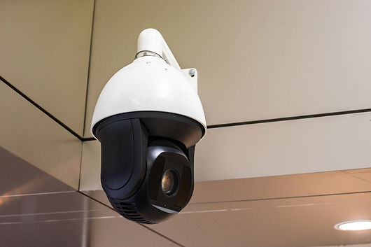Closed-circuit television (CCTV) security camera monitoring a building