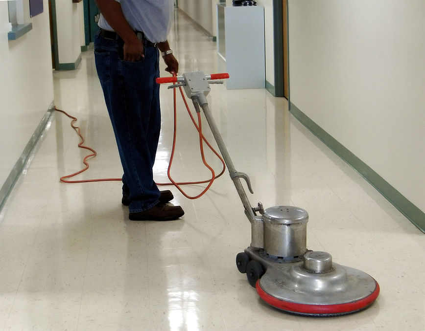 Commercial floor buffing machine in a hallway