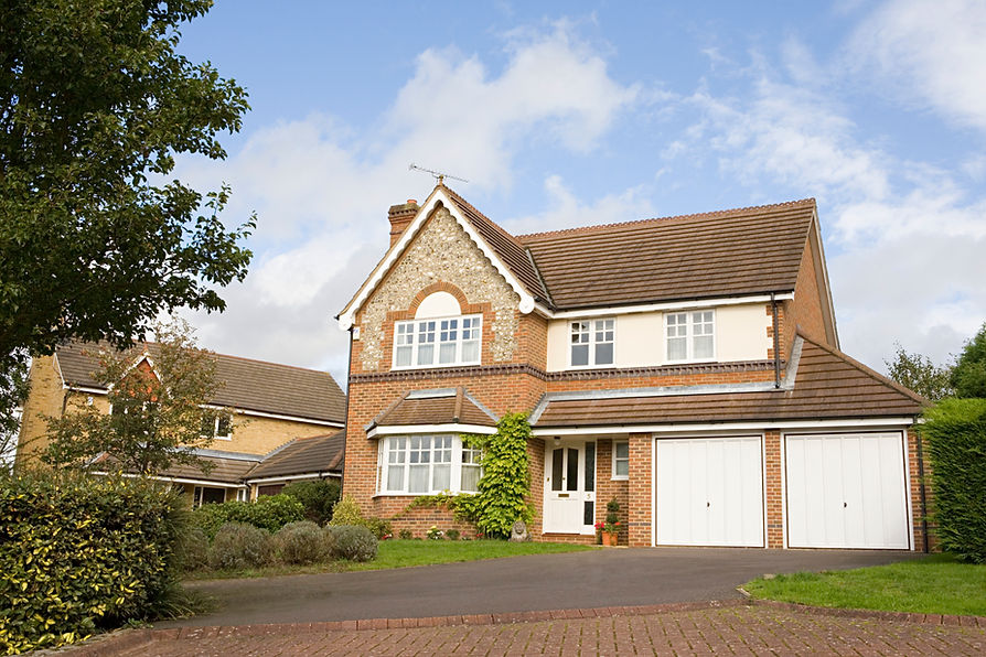 Modern detached brick house with integrated double garages and paved driveway