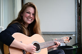 Woman practicing guitar.