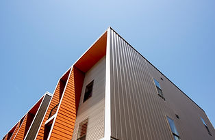 Upward facing photo of the top section of an orange and tan condo penthouse