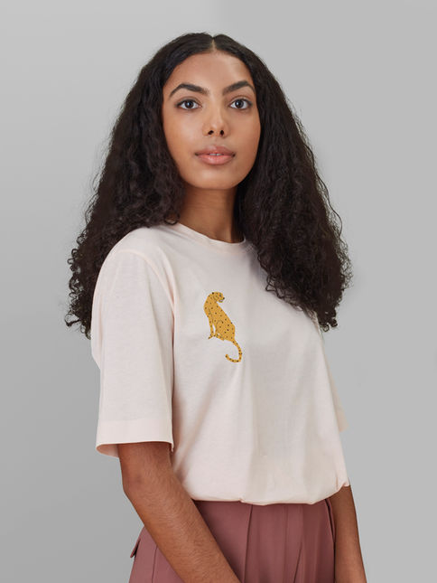 Woman modeling a cheetah top