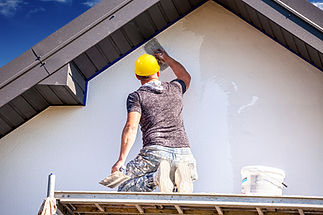 Applying silicone plaster to the wall of the house. Plastering wall