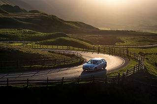 Car driving through scenic landscape