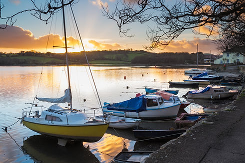 Blurred background showing the warm golden lights of a marina workshop at dusk