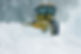 A yellow snowplow clears a snow-covered road